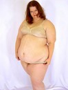 Huge fat red haired slut strips her dress and plays in beige lingerie losing it