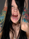 Naughty chick showing her tattoos and braces