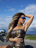 Busty chick Ferrari in tight fit mini dress does some modeling on the highway