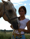 Canadian teenie feeding her horse