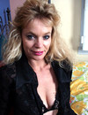 Playful mature blonde strips down to her black lingerie and flashes her shaved cunt