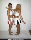Cute cheerleader poses in black and white uniform and flashes her tight panties