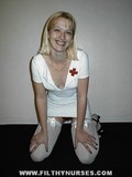 Blonde haired girl in tight white nurse uniform and stockings shows her red panties