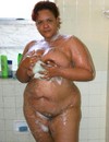 Frisky thick mature washing her huge boobs and puffy vagina in the shower