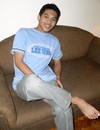 Asian twink poses on the sofa feeling a bit shy then strips and strokes his rod
