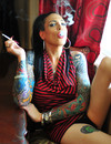 Tattooed transsexual brunette Nicole Dupre smokes a cigarette and bares her amaz