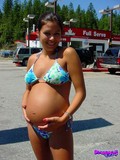 Playful pregnant brunette playfully flashes her juicy tits in the open air
