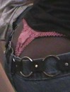 Lewd doll displaying her silk pink panty while sitting on the chair outdoors