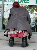 Redhead secretly filmed when sitting down and exposing her butt in sheer red pan