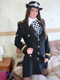 British police girl in uniform poses and strips showing her long legs in black p