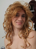 Cute faced playful guy crossdressed for your excitement and poses in lingerie and wig