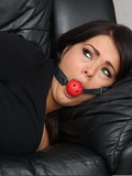 Ball gagged brunette with her wrists and ankles tight together is totally helpless