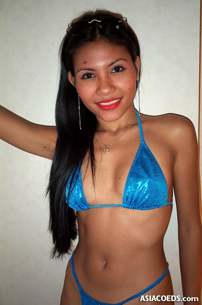 Luscious Filipino teen doll in shiny blue bikini shows off while posing and...