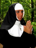 Perverted nun in stockings goes on her hunkers and greedily sucks hard stick