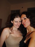 Clothed dark haired latina tranny and her girlfriend pose together at home