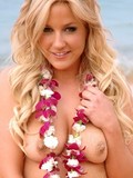 Luscious blonde teen Lia plays at the coast trying to hide her tits behind the flower leis