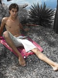 Young boy is posing outdoor and sliding the shorts down willing to demonstrate cock