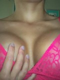 Naughty amateur girl in pink top makes no secret of her firm round boobs