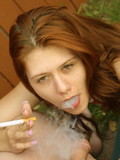 This redheaded chick never gives up smoking, even while crazy cock sucking