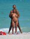 Topless big titted blonde caught playing with her boyfriend on the beach by the ocean