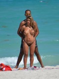 Topless big titted blonde caught playing with her boyfriend on the beach by the ocean